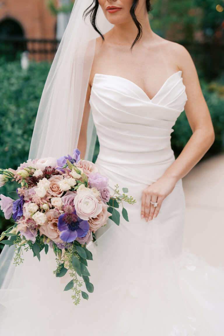 Bride holding an elegant floral bouquet while wearing a couture wedding gown and veil, professionally managed by an experienced wedding coordination team in Metro Atlanta.