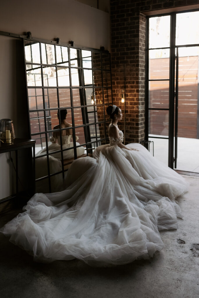 Elegant bride Annie in a Grace Kelly&ndash;designed luxury wedding dress during her wedding to Vik at 42West Entertainment Group in Atlanta, Georgia.